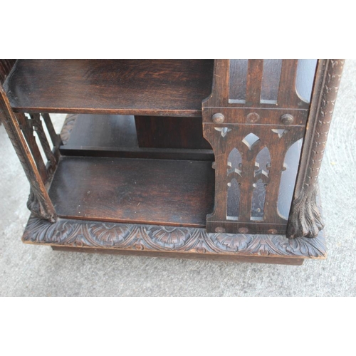 550 - A late Victorian carved oak three-tier revolving bookcase with Gothic pierced sides, 25