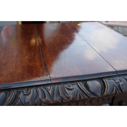 550 - A late Victorian carved oak three-tier revolving bookcase with Gothic pierced sides, 25