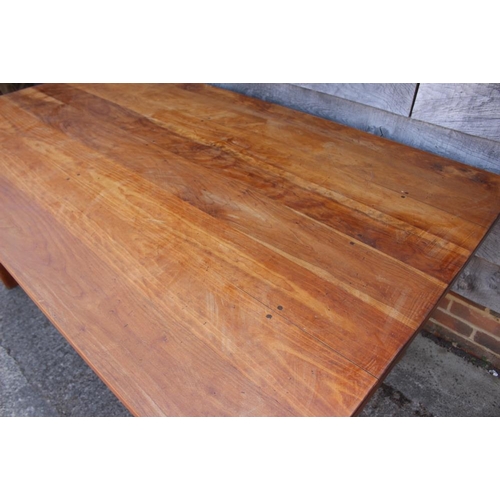 578 - A fruitwood dining table, on chamfered supports, 72