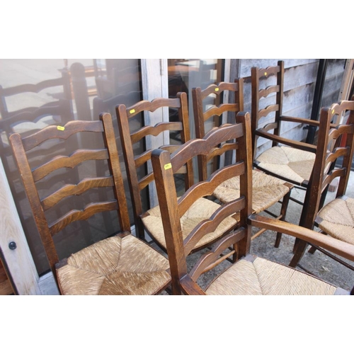 598 - A set of six oak ladder back dining chairs with rush envelope seats (2+4)