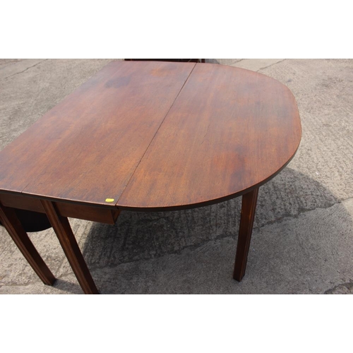 599 - A mahogany oval drop leaf dining table, on chamfered supports, 67