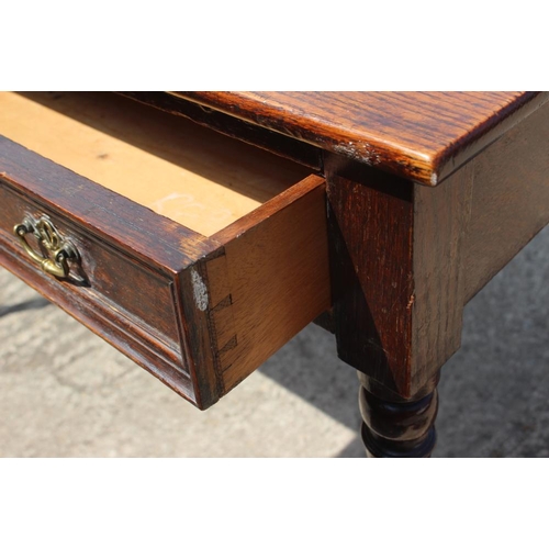 601 - An oak side table, fitted two drawers, on turned and tapering supports, 46