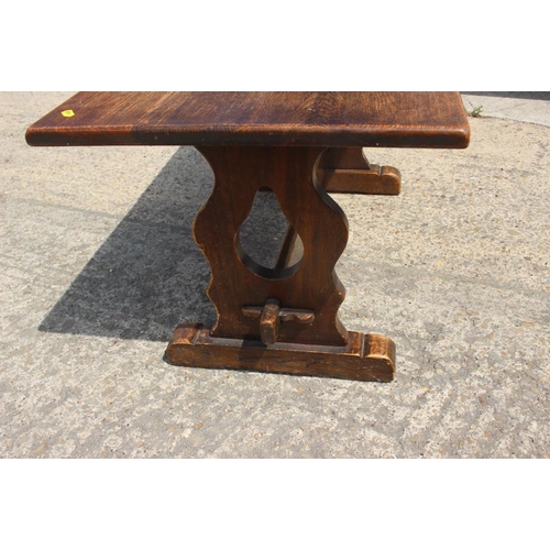 602 - An oak coffee table, on panel end supports, 36