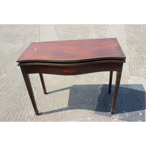 618 - A mahogany and inlaid serpentine front fold-over top tea table of Georgian design, on square taper s... 