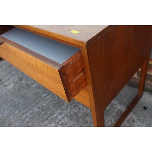 627 - A 1960s teak low dressing table, fitted mirror over four drawers, 54