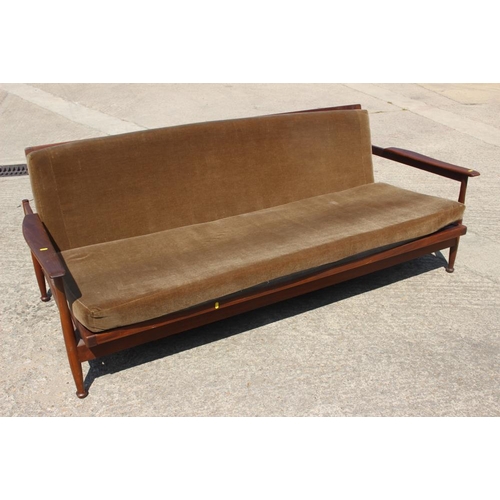 631 - A 1960s teak framed adjustable bed settee and a pair of matching armchairs, on turned supports (for ... 