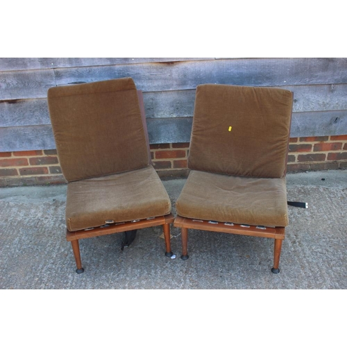 631 - A 1960s teak framed adjustable bed settee and a pair of matching armchairs, on turned supports (for ... 