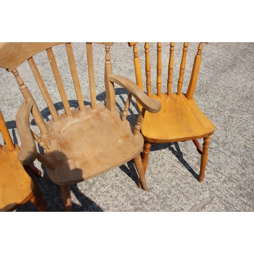 632 - A pair of lath back elbow chairs with panel seats and a pair of similar spindle back chairs