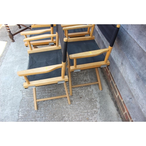 637 - Four director's folding chairs with black canvas seats and backs