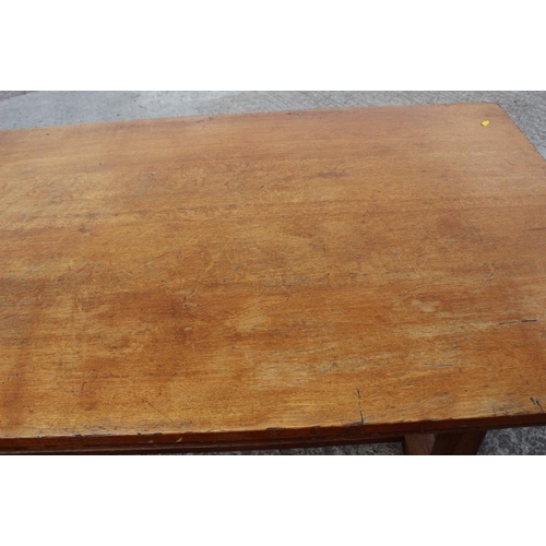 643 - A light oak refectory table, on twin chamfered supports, 78