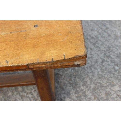 643 - A light oak refectory table, on twin chamfered supports, 78