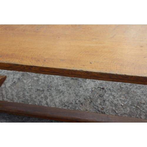 643 - A light oak refectory table, on twin chamfered supports, 78