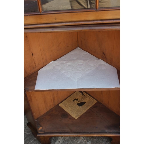 653 - An Edwardian walnut and line inlaid corner display cabinet, the upper section enclosed lattice glaze... 