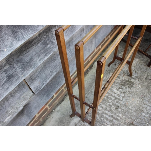 663 - An Edwardian walnut triple towel rail, on splay supports, 29