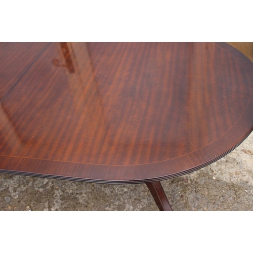 674 - A well reproduced mahogany and banded double pedestal dining table with extra leaf, 36