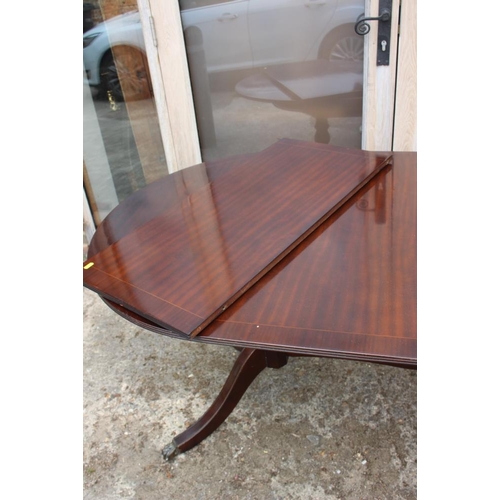 674 - A well reproduced mahogany and banded double pedestal dining table with extra leaf, 36