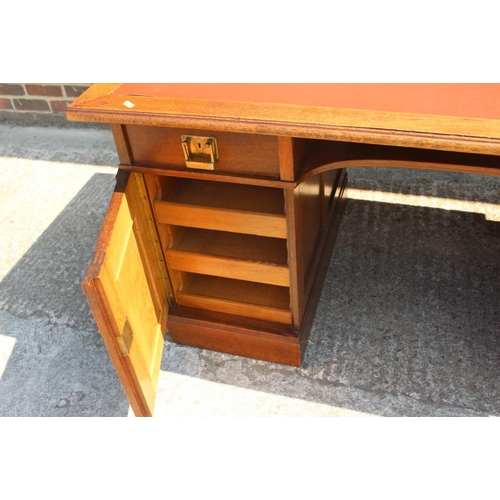 680 - An early 20th century oak desk of Gothic design, fitted two drawers and central recess over cupboard... 