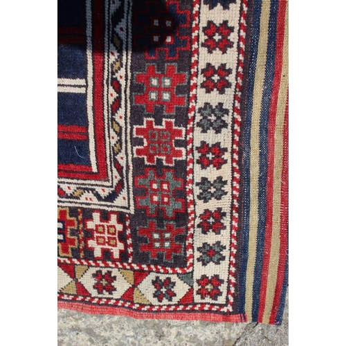 700 - A pair of Konya tribal rugs with lamp design on a red ground and multi-star borders in shades of red... 