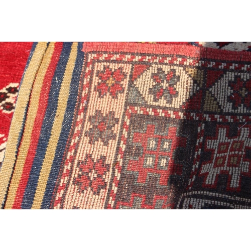 700 - A pair of Konya tribal rugs with lamp design on a red ground and multi-star borders in shades of red... 