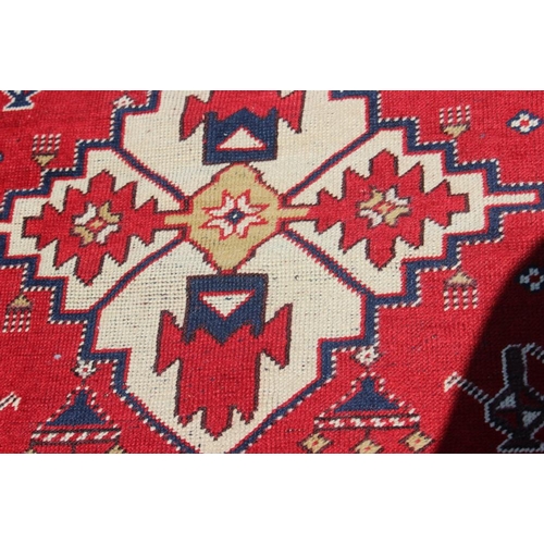 700 - A pair of Konya tribal rugs with lamp design on a red ground and multi-star borders in shades of red... 