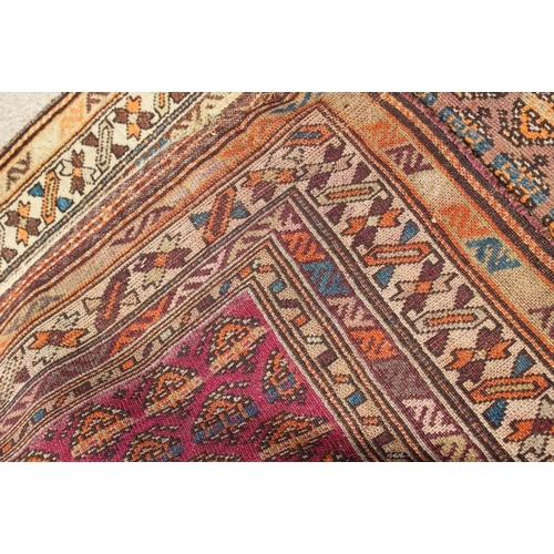 705 - A Caucasian runner with all-over boteh design on a plum ground and multi-bordered in shades of orang... 