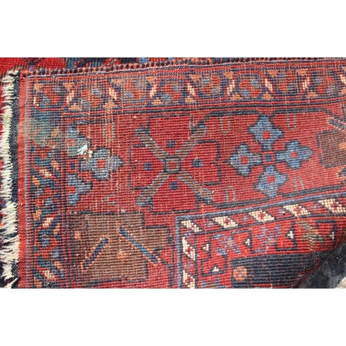 706 - A Hamadan type rug with all-over gul design on a blue ground and broad floral border, 66