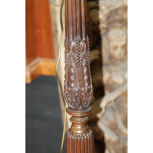 273 - A mid 20th century carved mahogany fluted column standard lamp, on tripod splay support with claw an... 