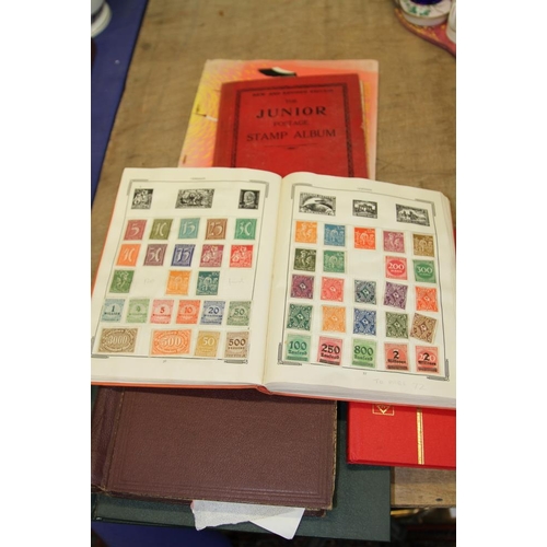 280 - Four stamp albums, containing loose stamps from around the world, and two boxes of loose stamps