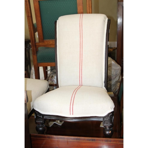 489 - A pair of late 19th century ebonised low seat occasional chairs, upholstered in a red striped linen,... 