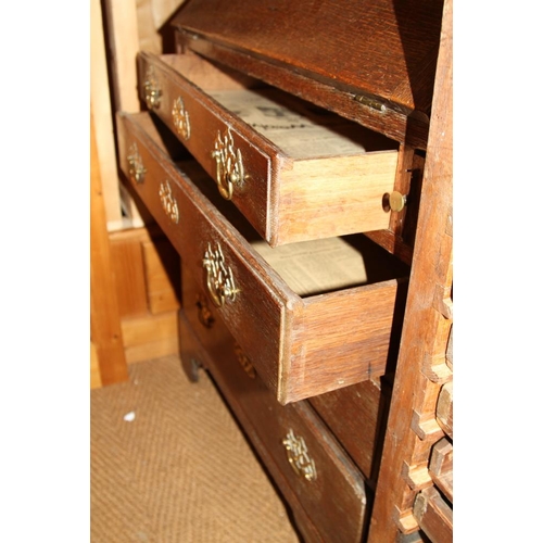 523 - A late Georgian provincial oak fall front bureau, the interior fitted drawers and pigeonholes over f... 