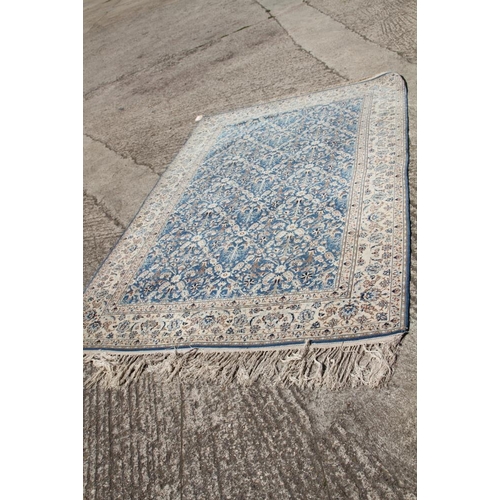 699 - A Persian Nain rug, finely woven with all-over floral design on a blue ground and multi-bordered in ... 