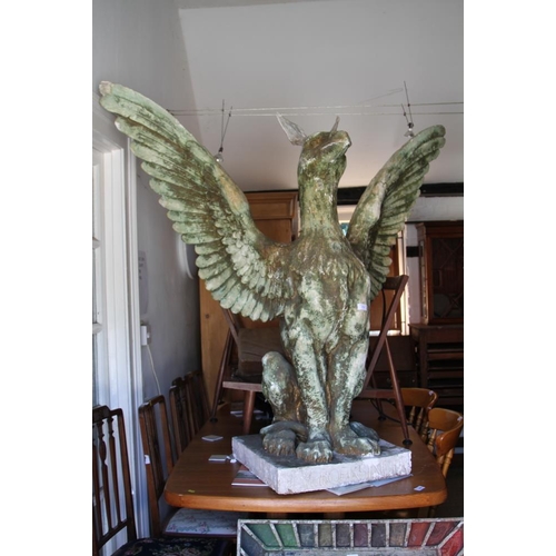 711 - J M Boekbinder: a patinated plaster and composition seated griffin, 64