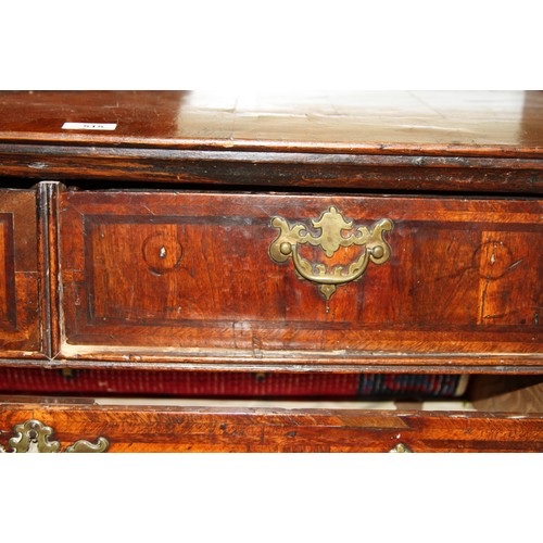 515 - An early 18th century figured walnut and inlaid chest of two short and three long drawers, on bracke... 