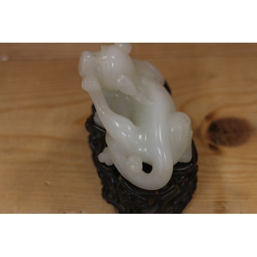 135 - A Chinese carved jade mythical beast, on hardwood stand, 3