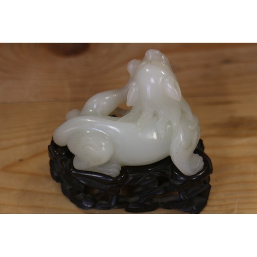 135 - A Chinese carved jade mythical beast, on hardwood stand, 3