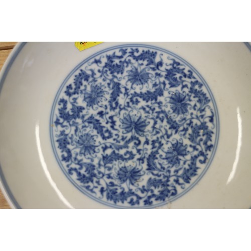 114 - A Chinese blue and white dish with scrolled and floral decoration and seal mark to base, 8