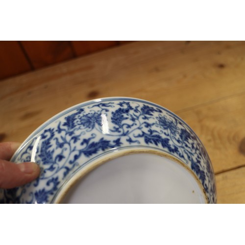 114 - A Chinese blue and white dish with scrolled and floral decoration and seal mark to base, 8