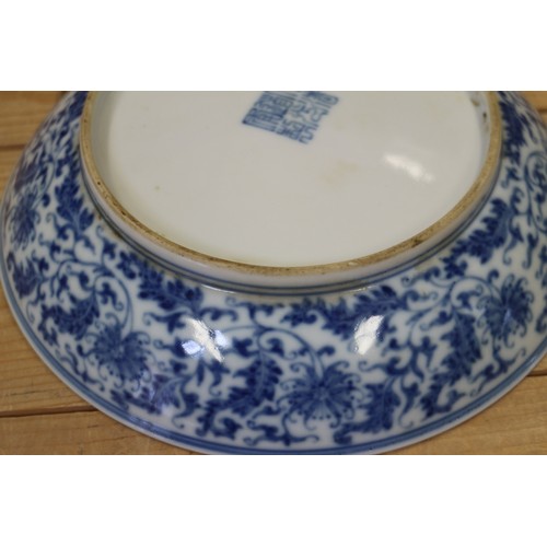 114 - A Chinese blue and white dish with scrolled and floral decoration and seal mark to base, 8