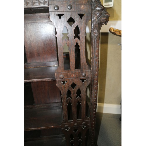 550 - A late Victorian carved oak three-tier revolving bookcase with Gothic pierced sides, 25