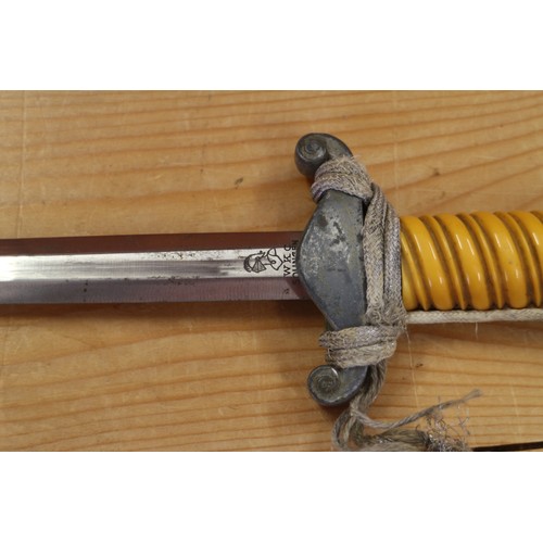 172 - An officer's German army dagger with strap and knot, in metal scabbard, maker WKC, 15 1/2