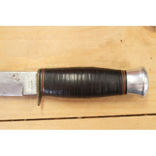 180 - A Bell's Bowie knife, in leather sheath, 9