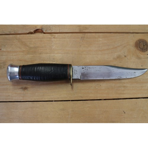 180 - A Bell's Bowie knife, in leather sheath, 9