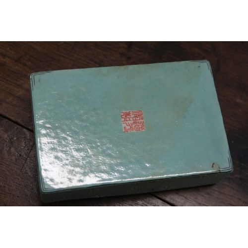 109 - A Chinese porcelain box and cover with verse and textured light green glaze, 4 3/4