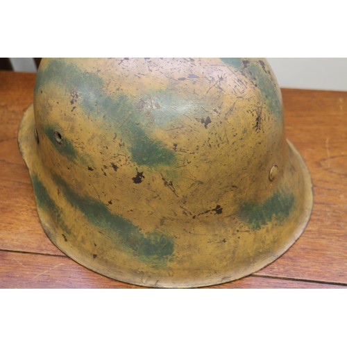 182 - An M42 camouflage helmet