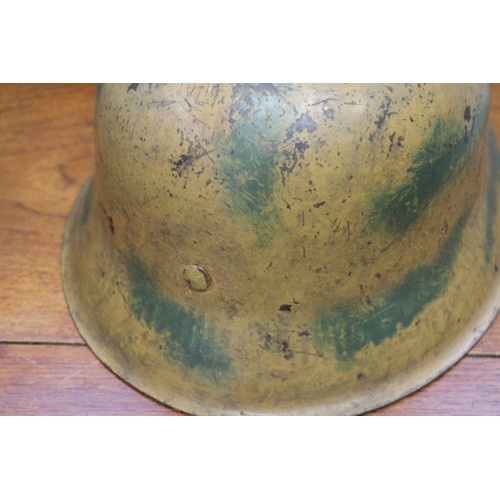 182 - An M42 camouflage helmet