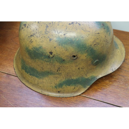 182 - An M42 camouflage helmet