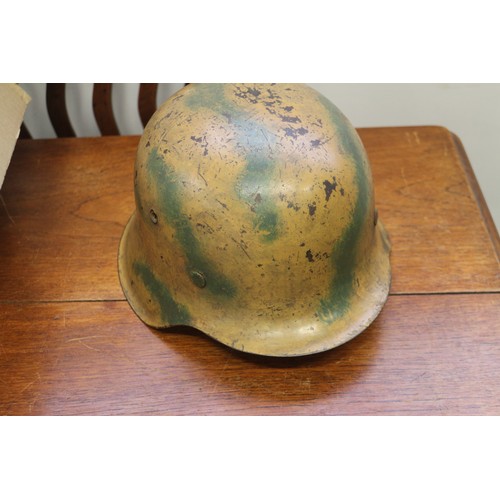 182 - An M42 camouflage helmet