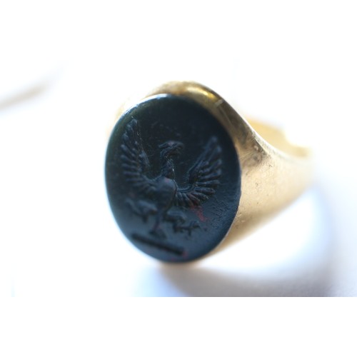 348 - An 18ct gold signet ring with engraved bloodstone intaglio, size O, 6.9g overall