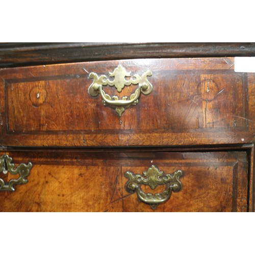 515 - An early 18th century figured walnut and inlaid chest of two short and three long drawers, on bracke... 