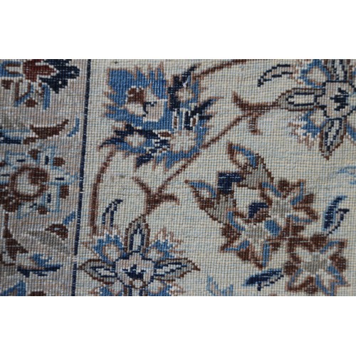 699 - A Persian Nain rug, finely woven with all-over floral design on a blue ground and multi-bordered in ... 